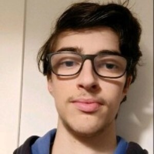 Young man with glasses and blue sweatshirt.